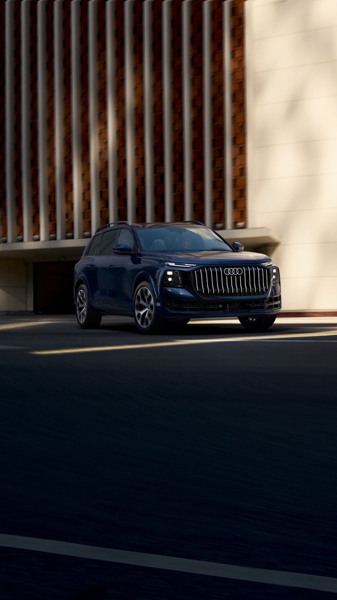 Three-quarter view of an Audi Q9 driving through the city.