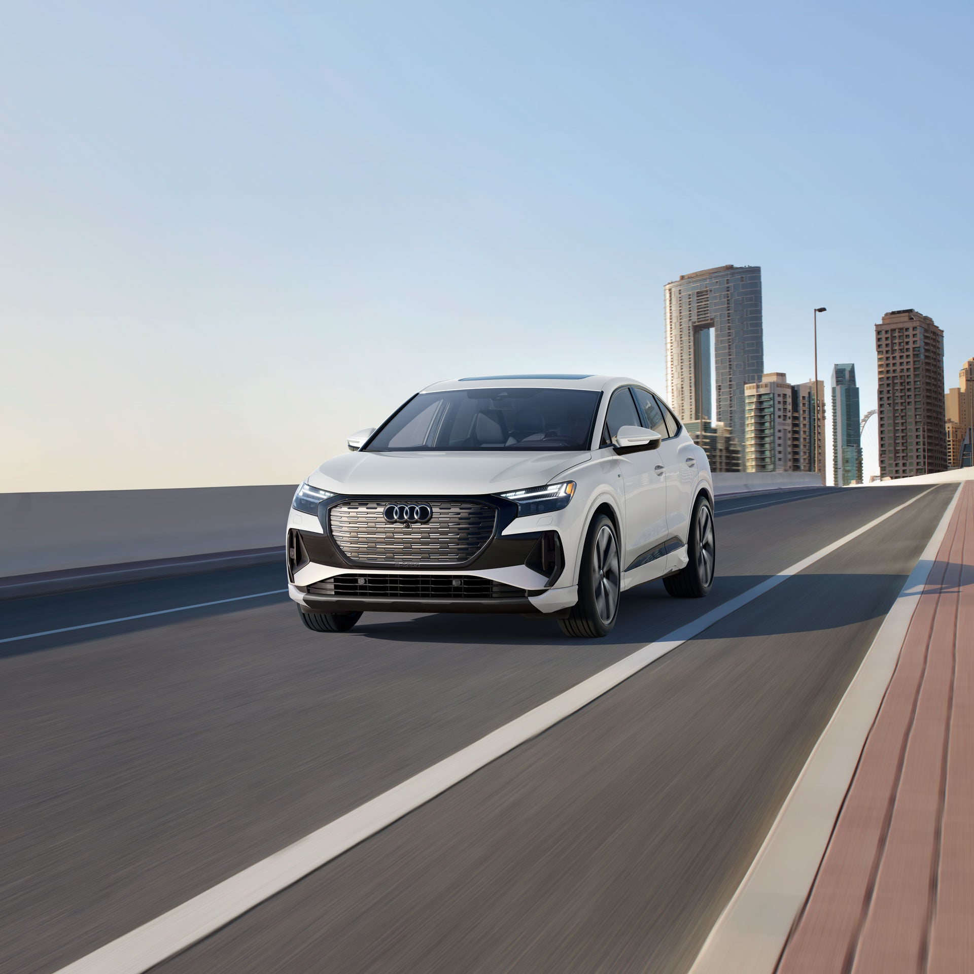 Front profile of the Audi Q4 Sportback e-tron accelerating.