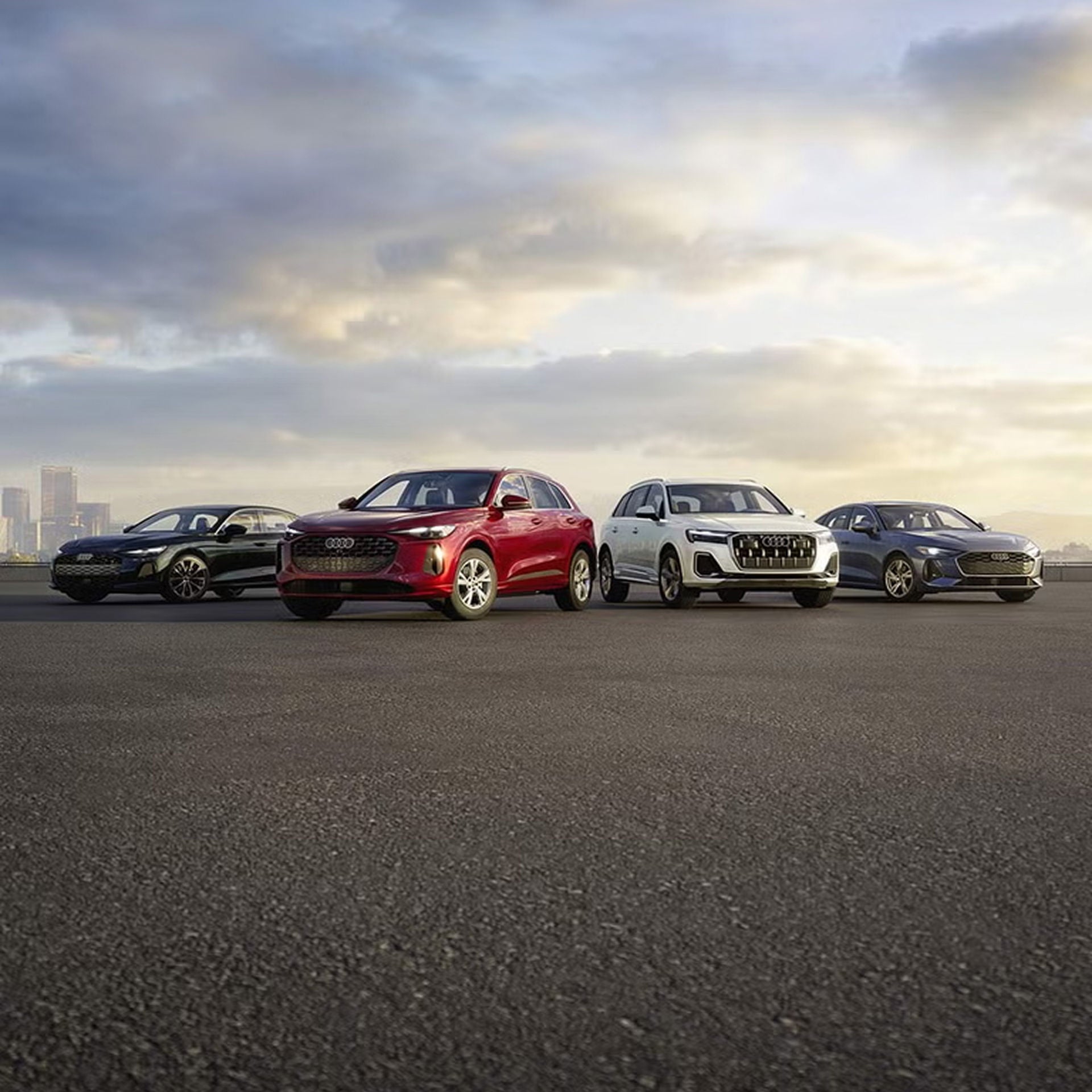 A line-up of Audi vehicles parked. 