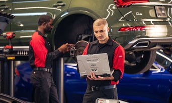 Service technician looking into a computer.