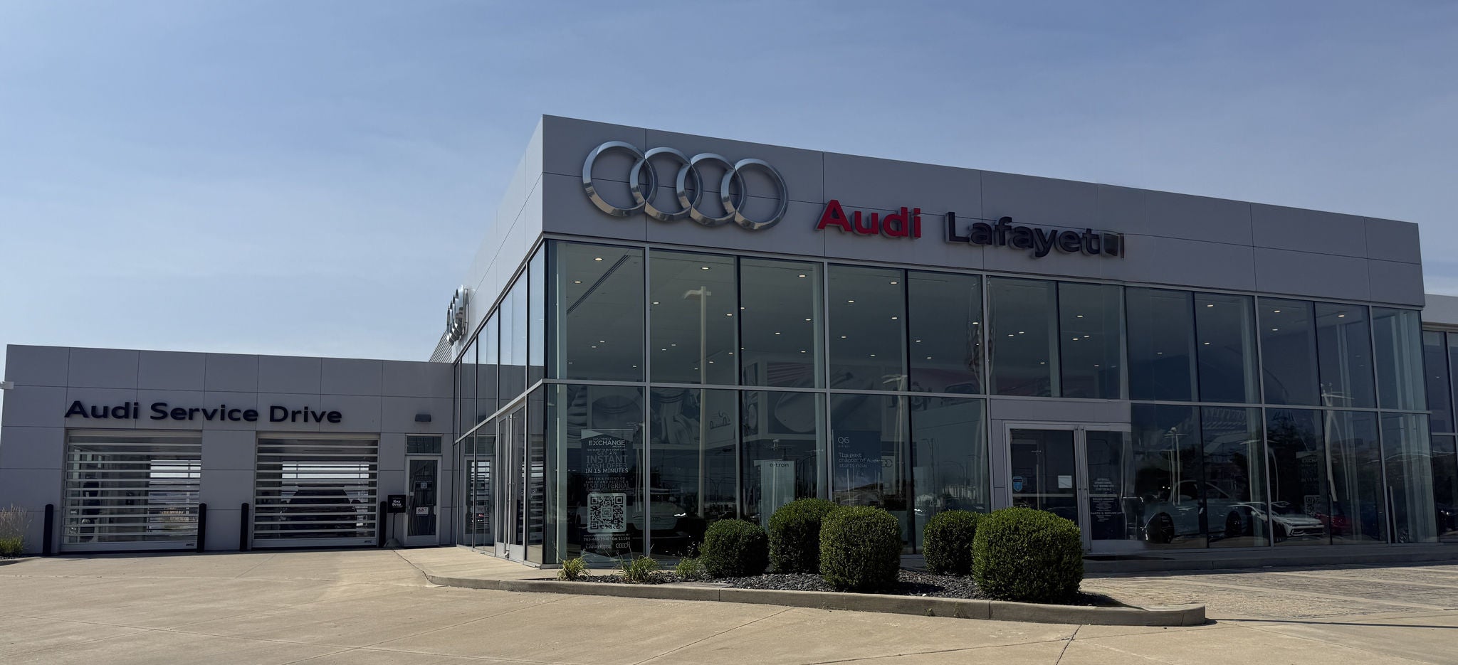 Audi Sale Specialist walking through the showroom with a couple.