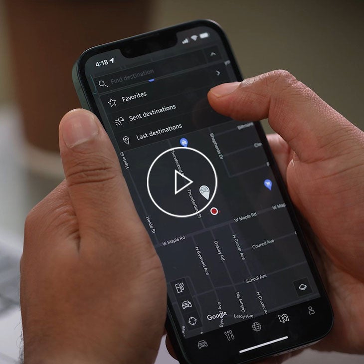 Close up on a mobile phone displaying the myAudi app.