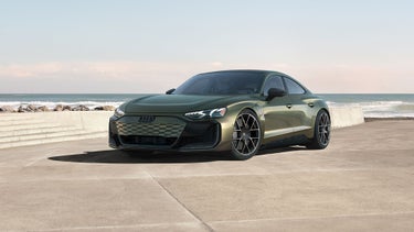 Front profile of the Audi Q8, showing the lit up LED headlights.