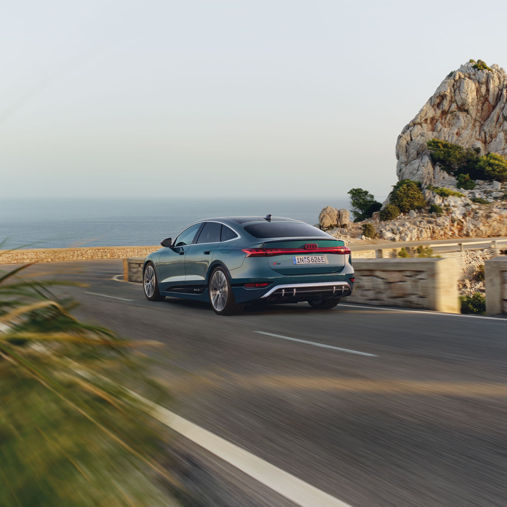 Rear 3/4 view of the Audi A6 Sportback e-tron in motion.