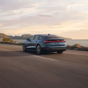 Rear 3/4 rear view of the Audi A6 Sportback e-tron in motion.
