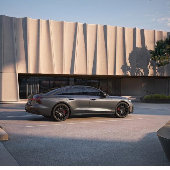 2026 Audi A6 side profile parked architectural building at Audi Sewickley near Pittsburgh PA