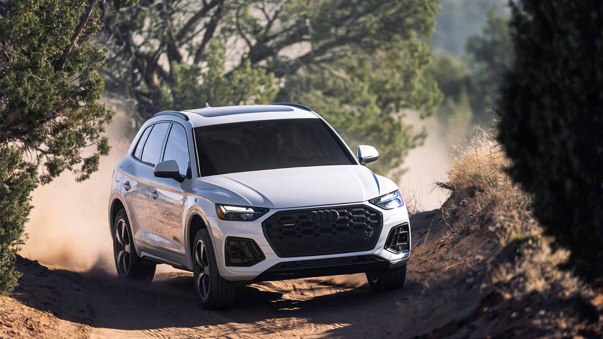 3/4 view of Audi Q3 accelerating in sand