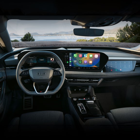 Close-up on the wraparound virtual cockpit in the driver's cabin of the Audi A6 e-tron.