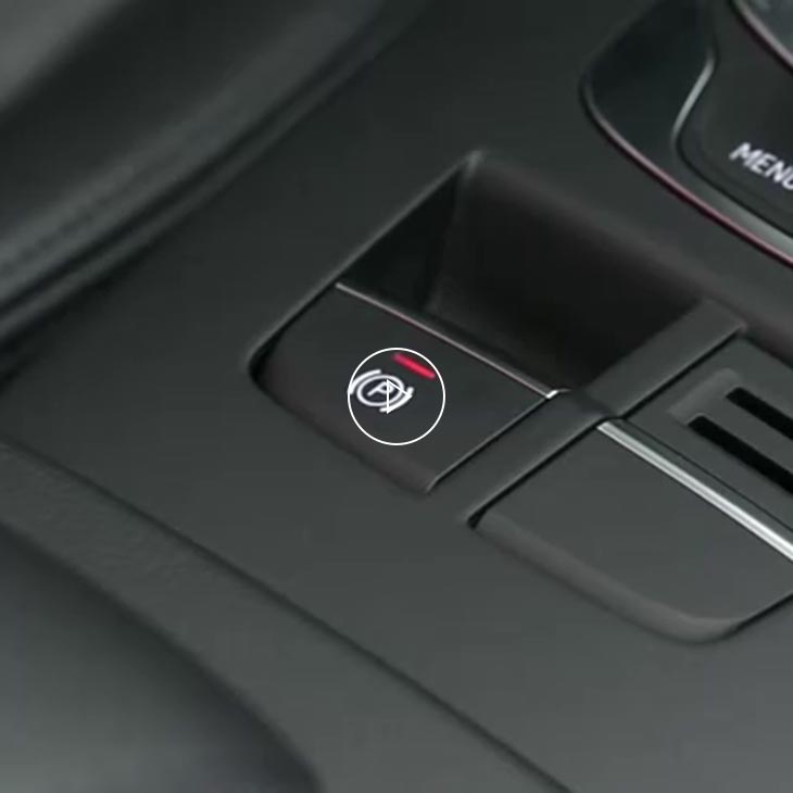 A close-up photo of the parking brake knob inside an Audi vehicle.