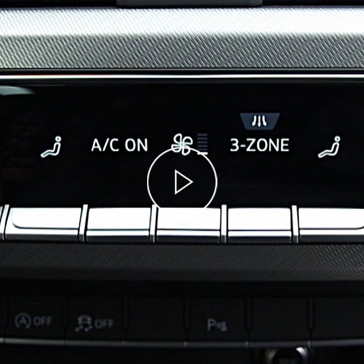 Close-up photo on 3 zone automatic climate control options inside an Audi vehicle. 