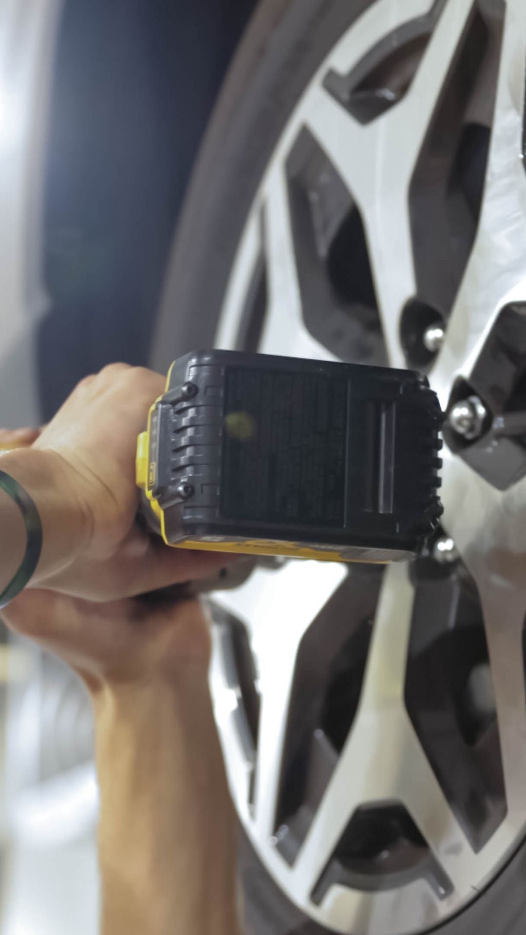 Service technicians servicing tires.
