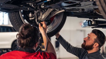 Audi technician inspecting vehicle.