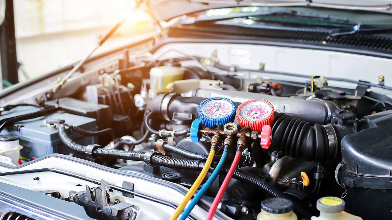 Audi maintenance technician working on AC system
