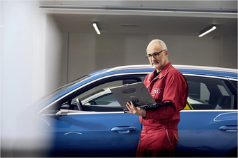 Audi technician servicing a vehicle 