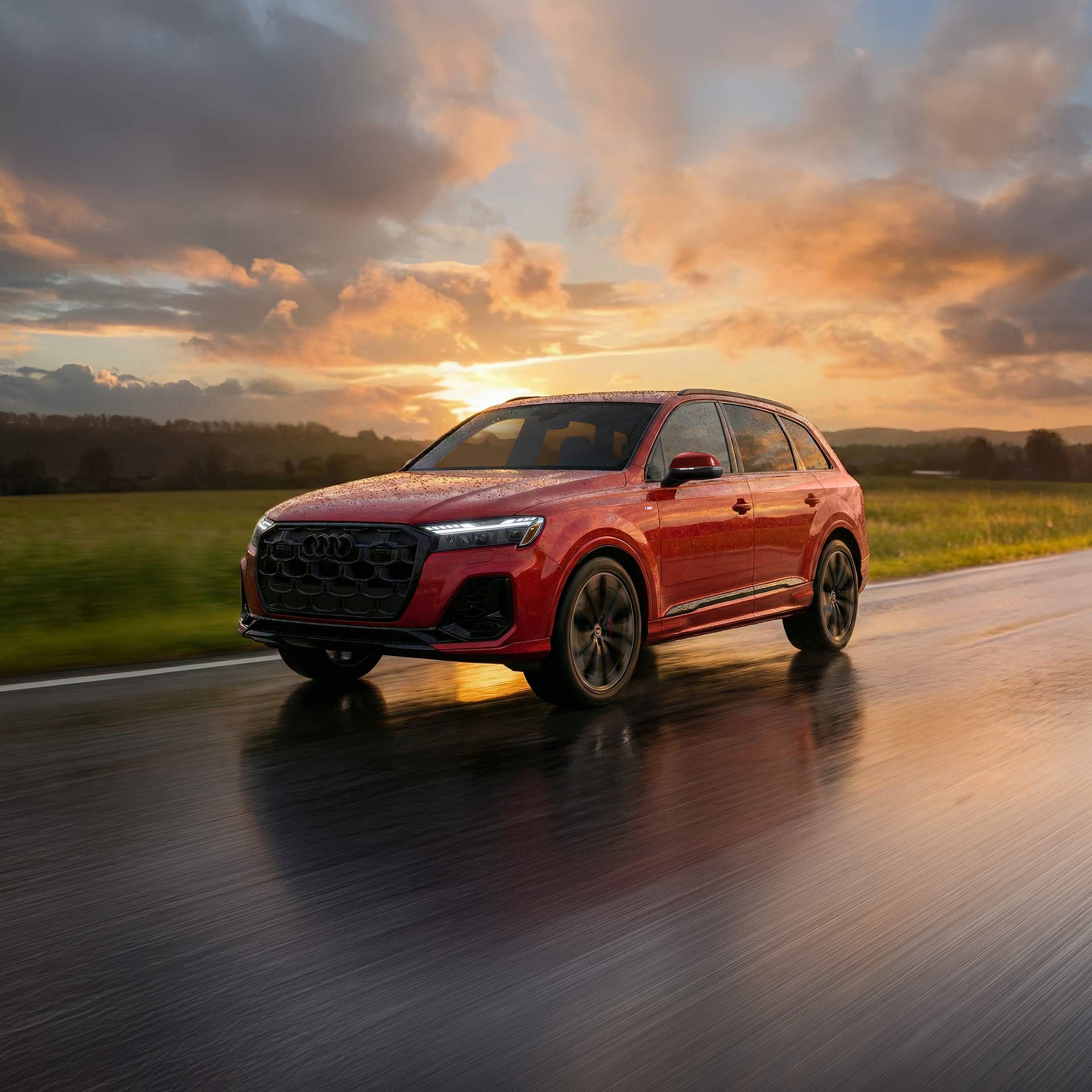 Three-quarter front profile of an Audi Q6 e-tron accelerating.