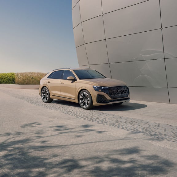 Elevated three-quarter front profile of the Audi Q8. 