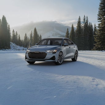 Audi A3 equipped with winter tires parked on a snow-covered road