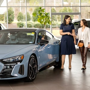 Customers exploring the Audi showroom — view current offers at Audi Sewickley near Pittsburgh
