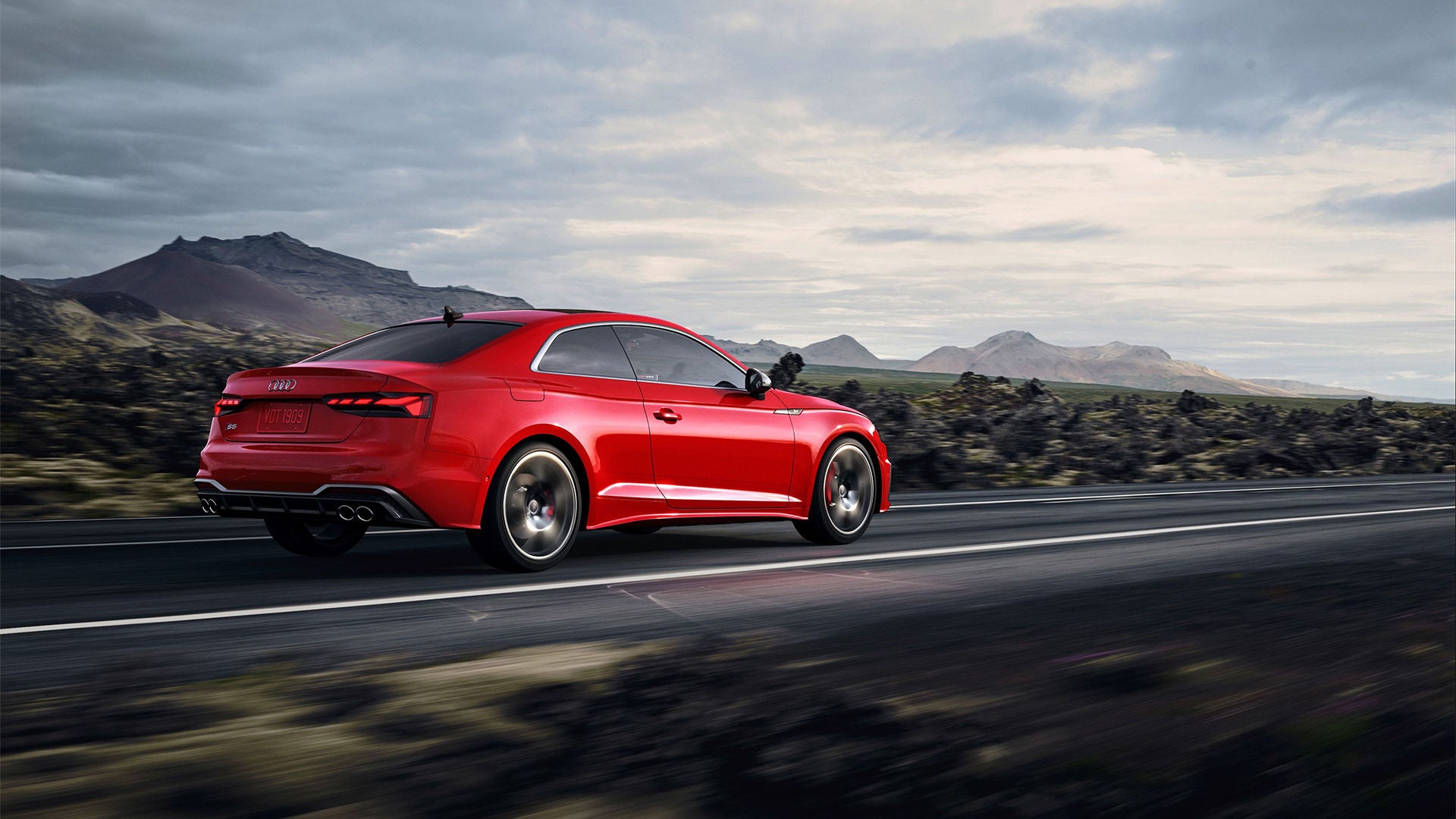 A red Audi trade-in vehicle on the road