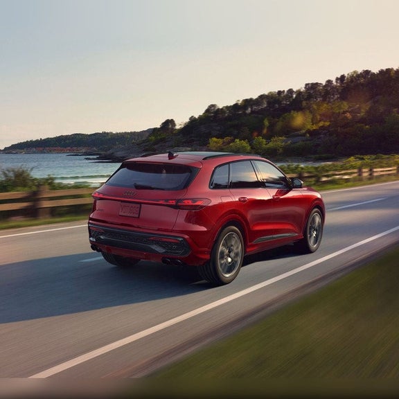 2026 Audi SQ5 rear view driving along a coastal road near Audi Sewickley Pittsburgh PA