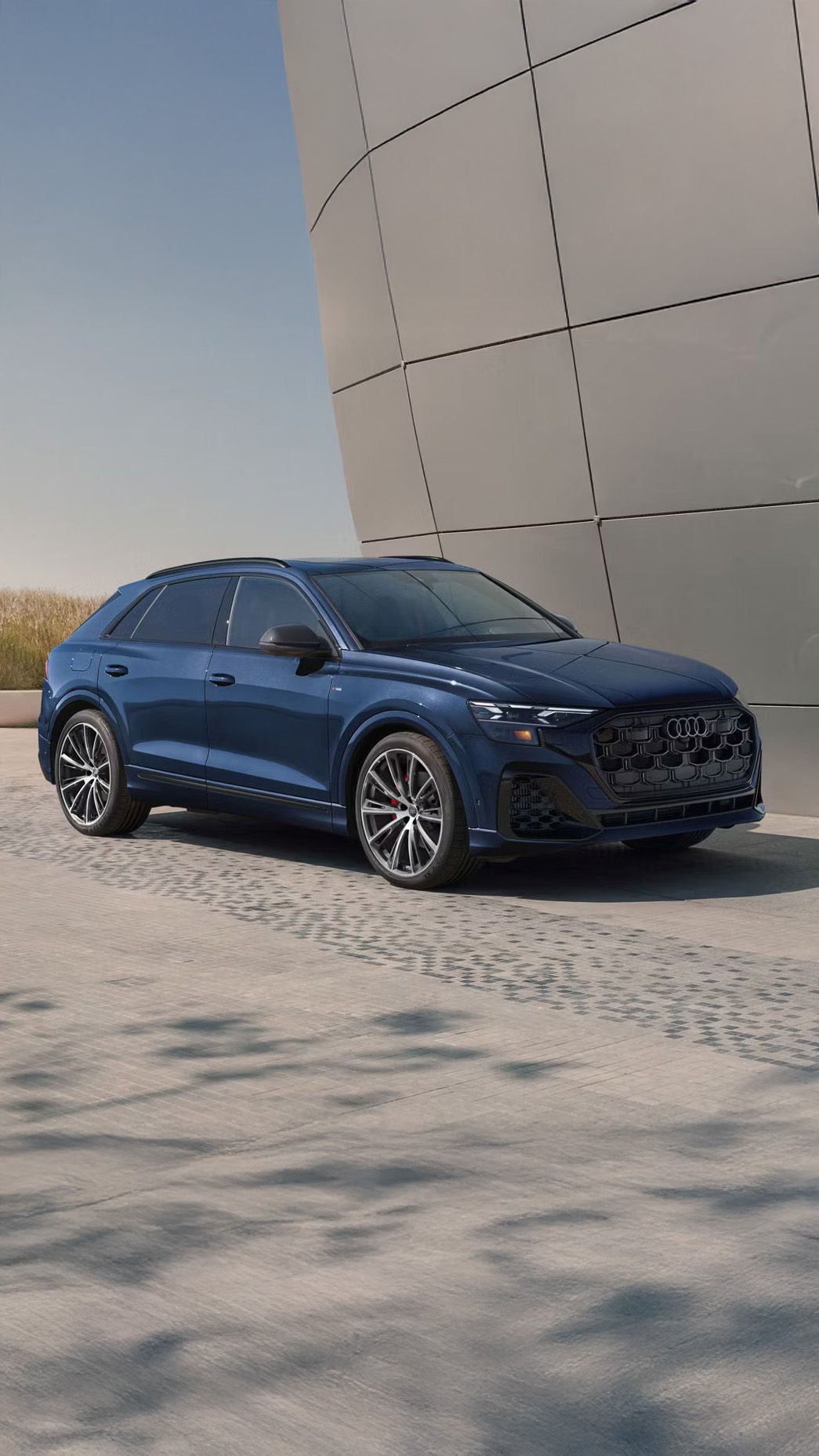 2026 Audi Q8 trim level in blue parked by modern building