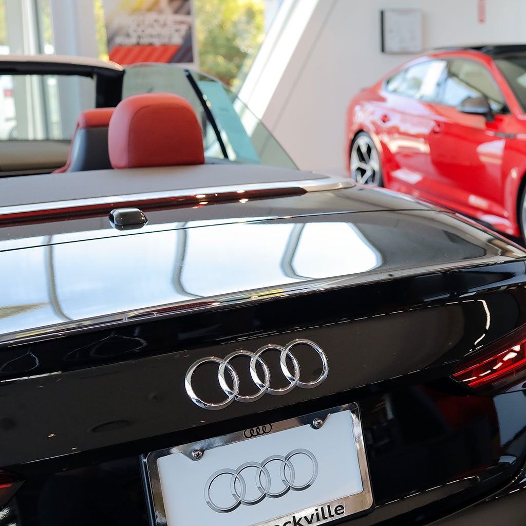 Two Audi vehicles in a showroom.