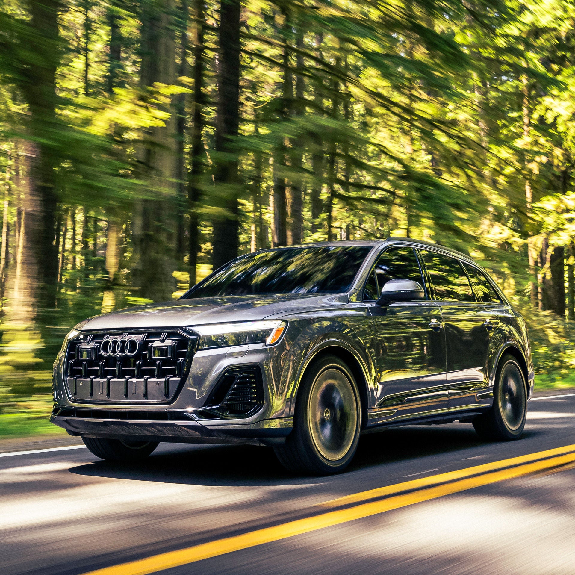 Audi 2025 Audi Q7 left profile driving.