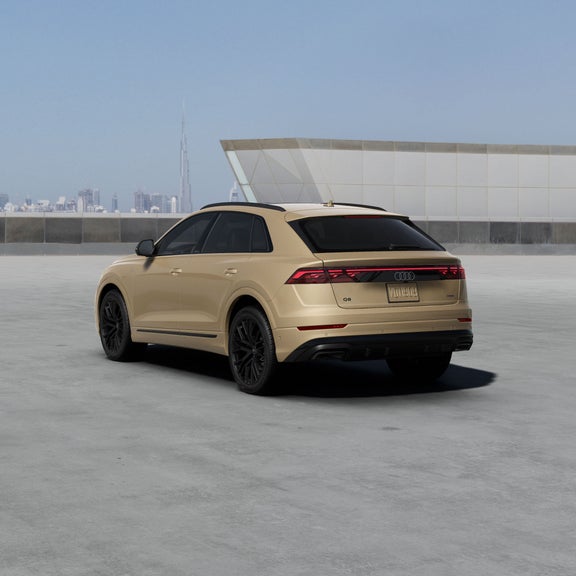 Three-quarter rear view of the Audi Q8 accelerating.