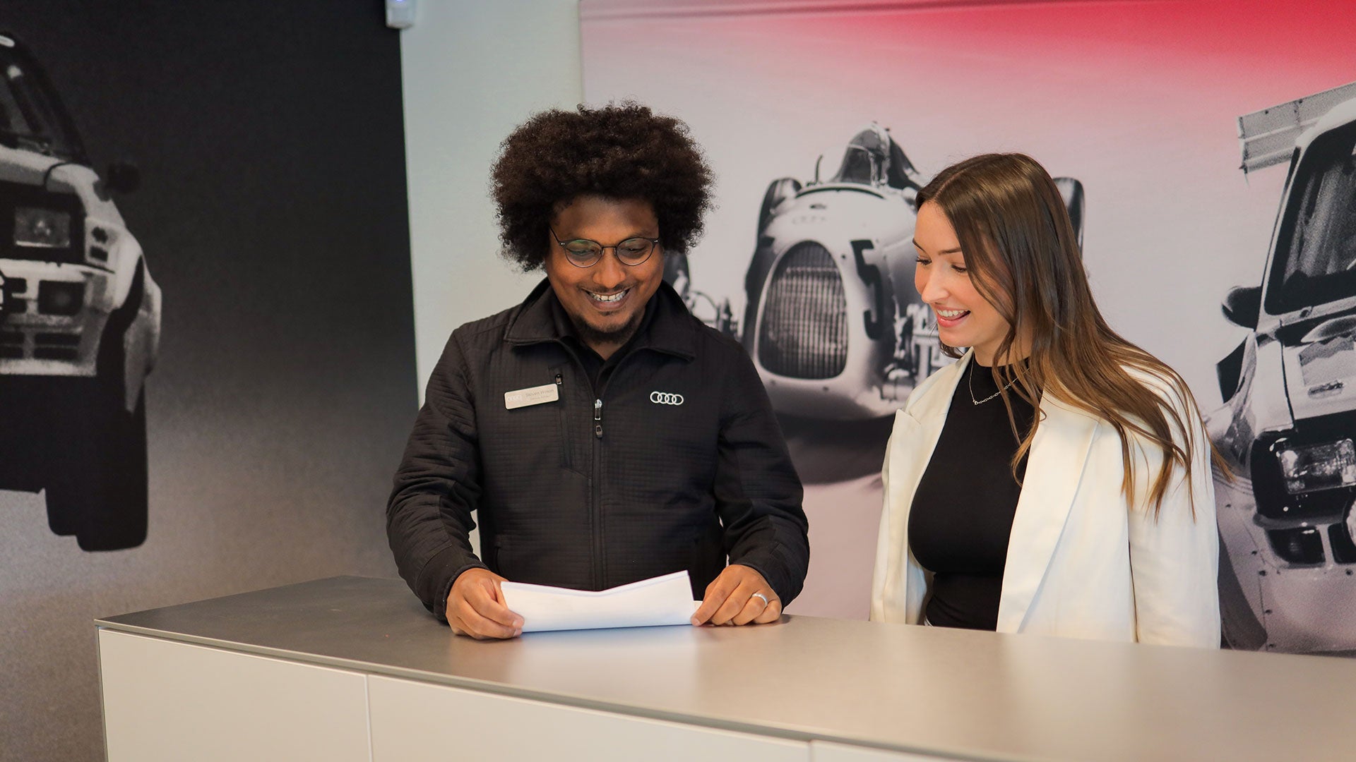 Audi Service Advisor and customer reviewing document