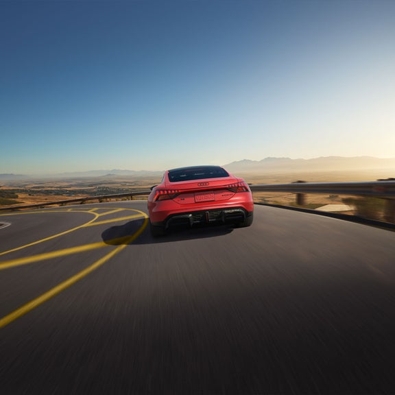 Rear view of the Audi RS e-tron GT accelerating.