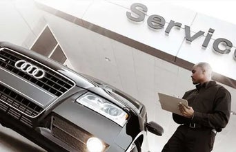 Service technician assessing vehicle. 