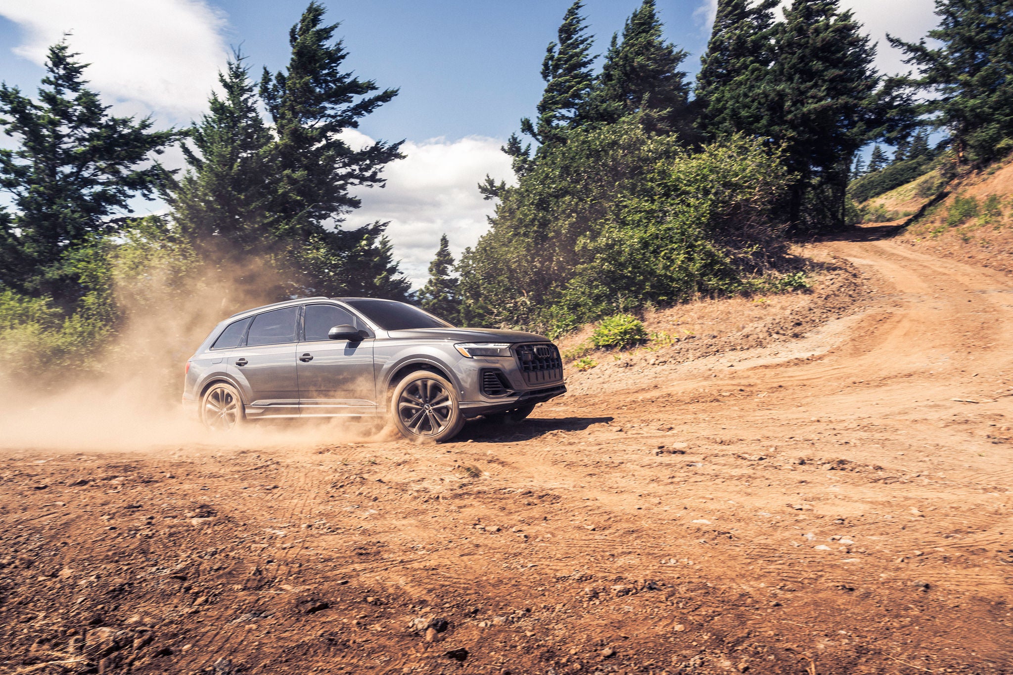 Audi Q7 driving on a dirt road