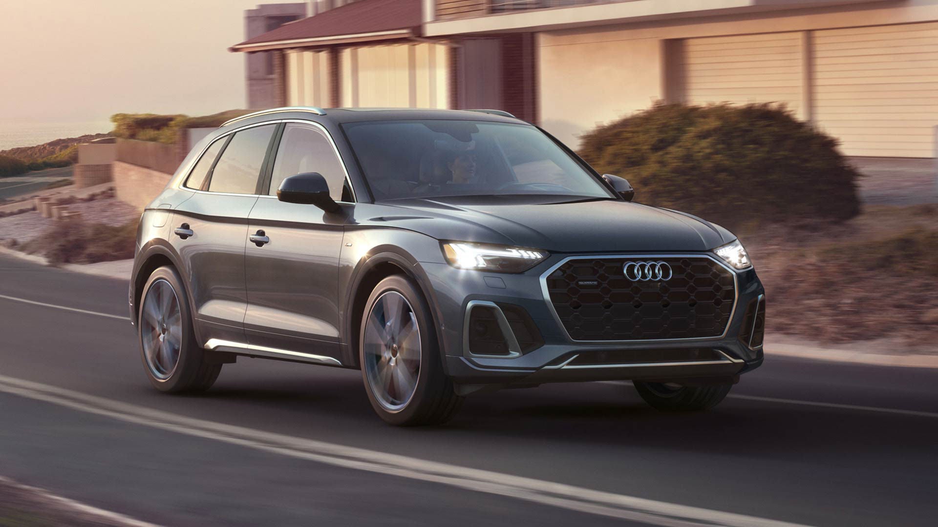 Side view of an Audi Q5 Hybrid driving.