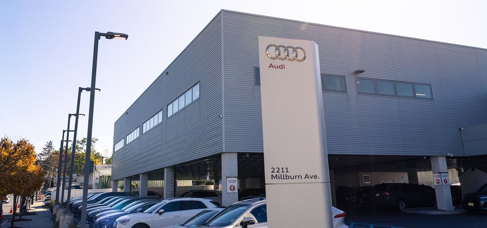 Audi Sale Specialist walking through the showroom with a couple.