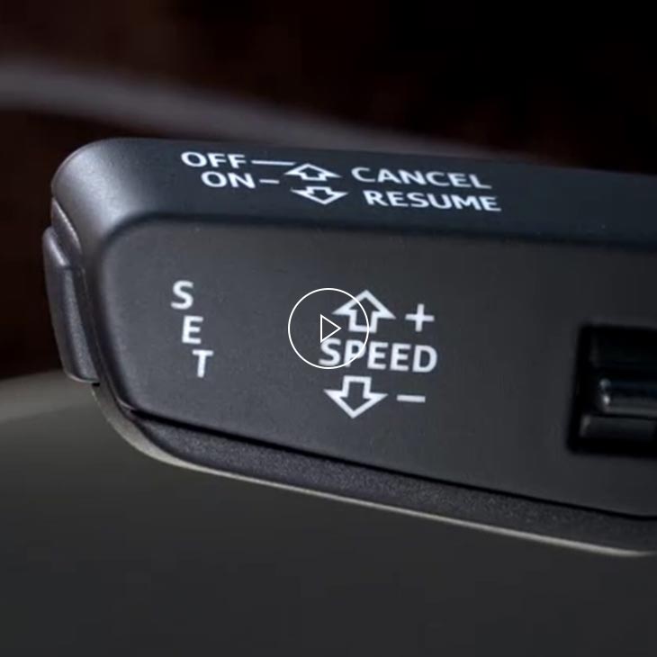A close-up photo of the adaptive cruise control knob inside an Audi vehicle.