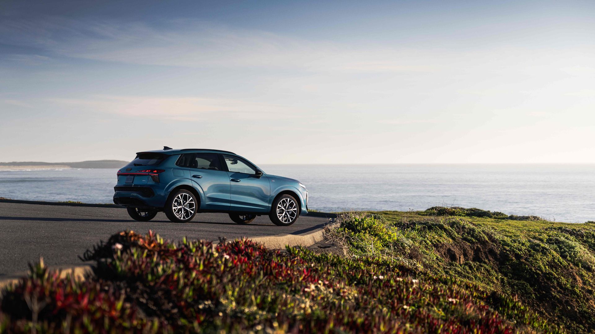 Rear profile view of an Audi Q3 parked.