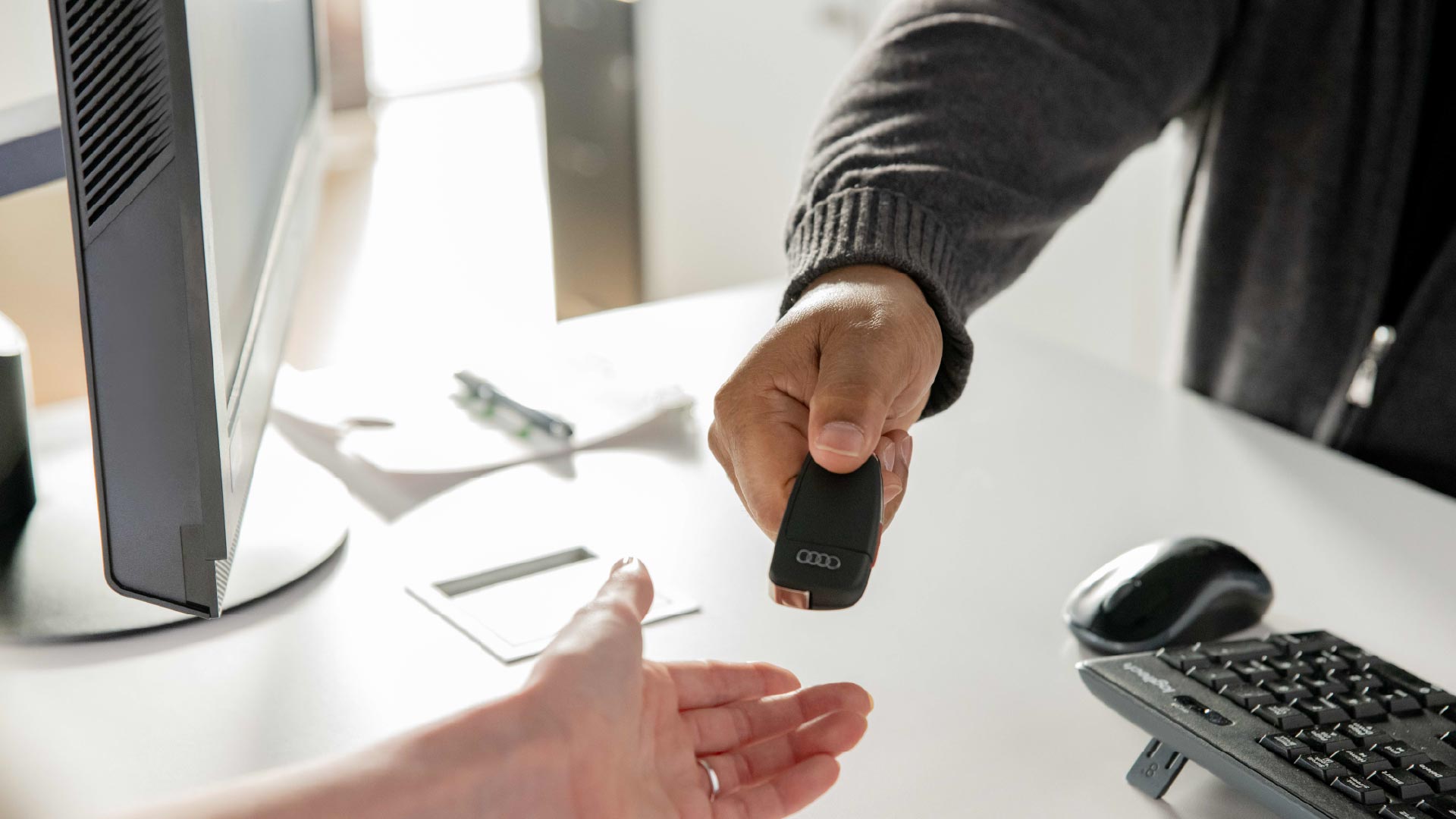 Audi finance specialist handing over keys to an Audi.