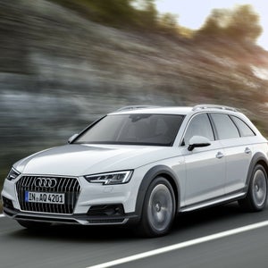 Three-quarter front view of the Audi A4 accelerating on a city road.