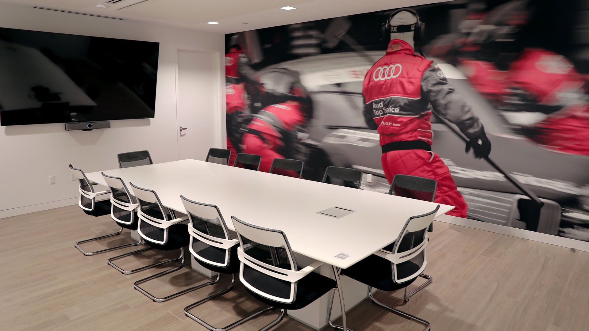 Audi Sale Specialist explaining vehicle features to a customer.