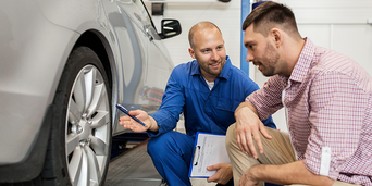 Service technician serving vehicle.