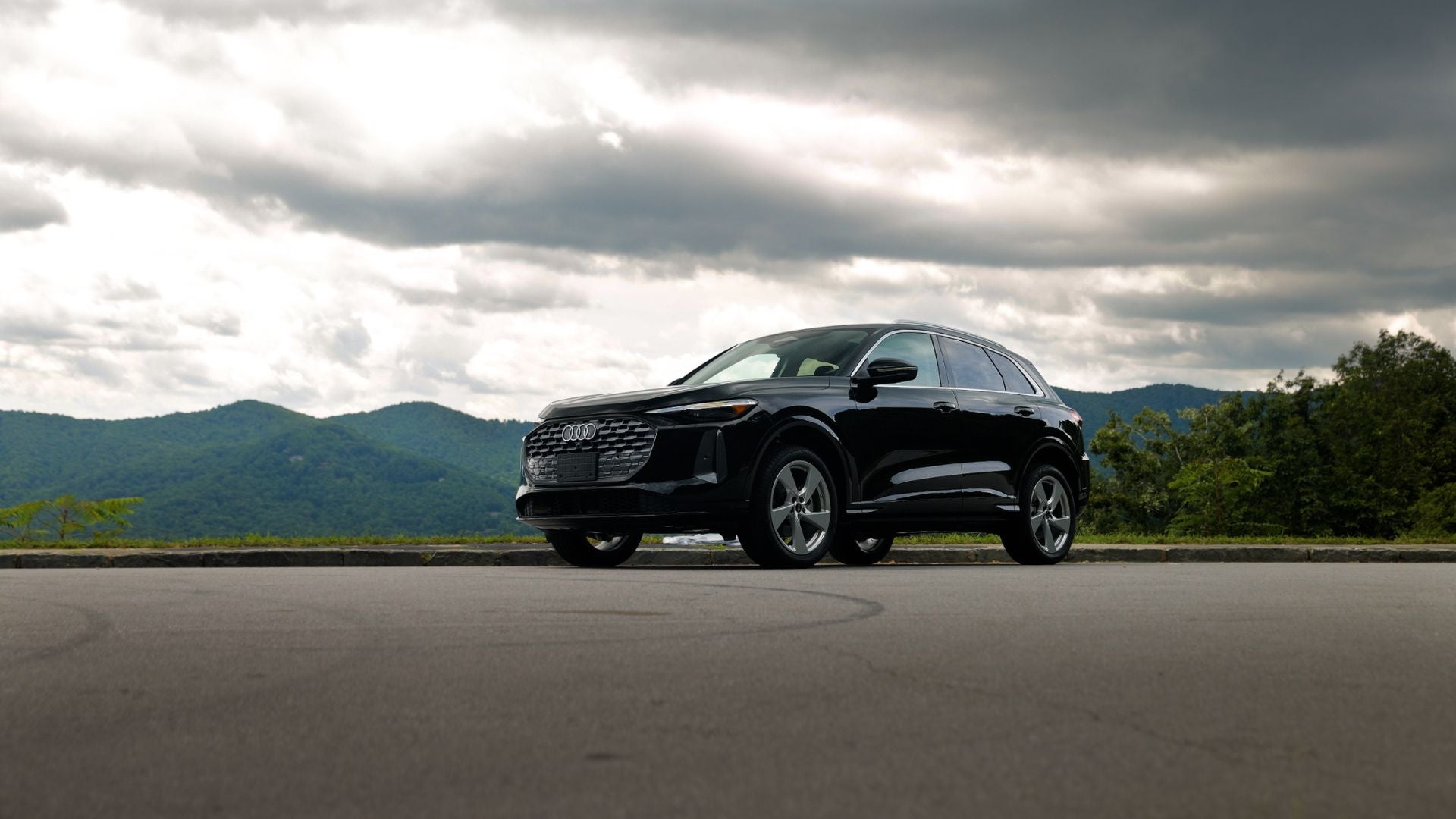 Audi Q5 SUV parked with mountains in the background