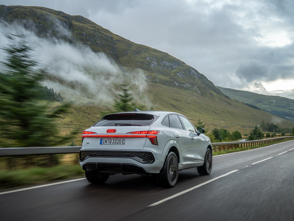 Rear driving photo of white 2026 Audi Q3