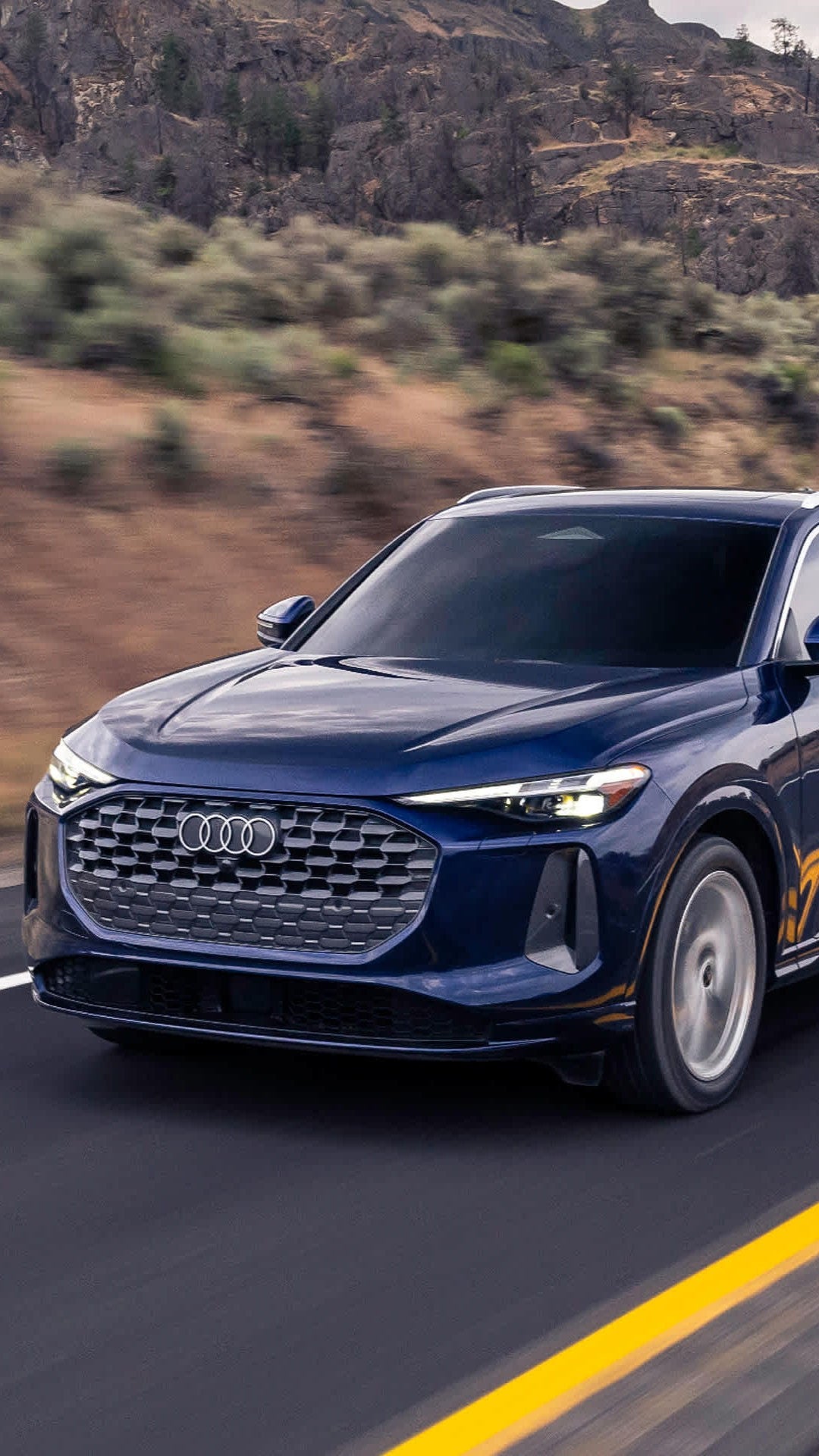 Audi 2025 Audi Q5 left profile driving.