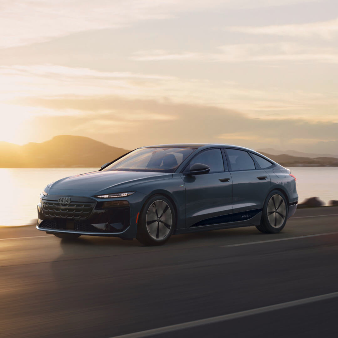 2027 Audi A6 Sportback e-tron Exterior Driving By Lake At Sunset
