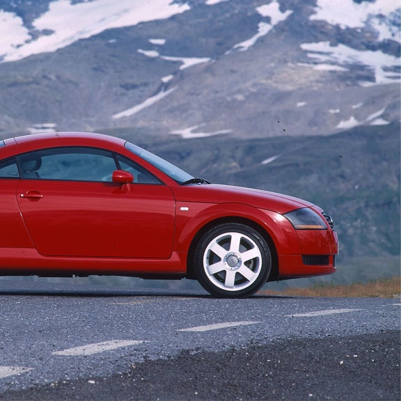 Side view of a red Audi TT Coupe parked on the road.