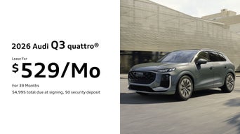 Left side profile of an Audi Q3 parked.