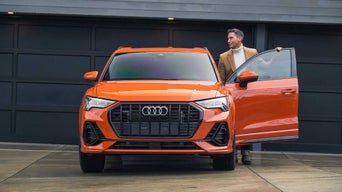 Driver parking orange Audi sedan