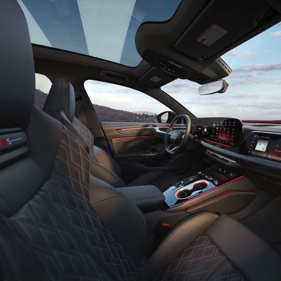 Interior of the Audi A6 Sedan, showing the front sport seats, dashboard, and center console.