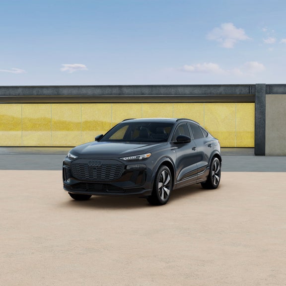 Three-quarter front view of a black Audi Q6 Sportback e-tron parked.