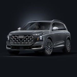 Grey Audi SQ9 shown from the front three-quarter view against a dark studio background.